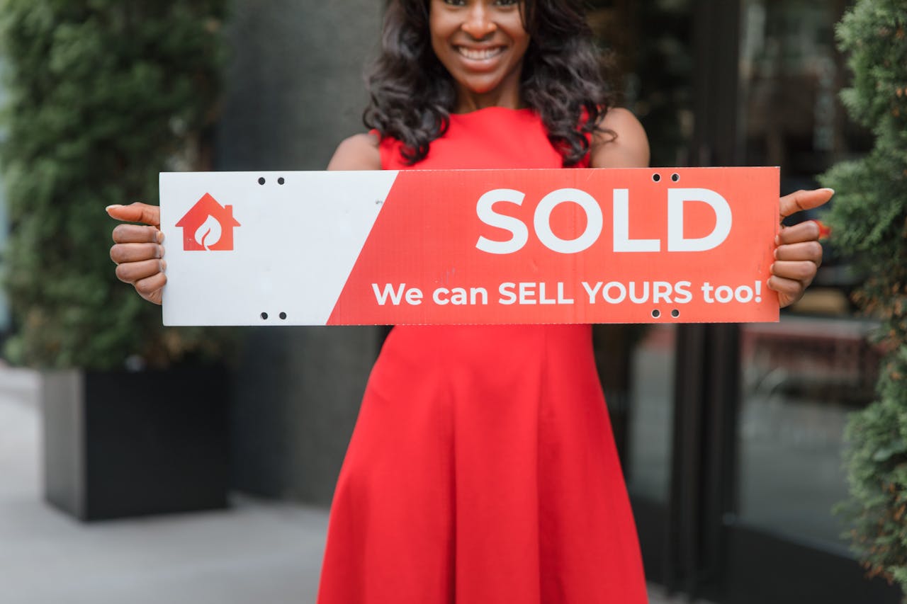 Crafting Captivating Headlines: Your awesome post title goes here Smiling woman holding a 'Sold' sign, symbolizing successful real estate sales.